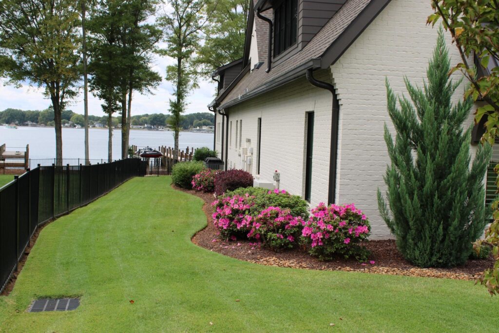 Hardscaping project in Concord NC with patio, lawn, and landscaped beds installed by Lawn Impressions